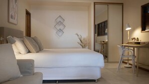 A bedroom with a bed, a desk, and a chair.