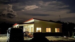A house with a red roof, a driveway, and a parked van. - Family House to enjoy by the beach (Pasuquin)