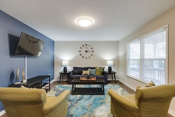 Spacious and inviting with a pull-out sofa bed (sleeps two), flat-screen Roku TV, and two cozy lounge chairs—perfect for movie nights or unwinding with company.
