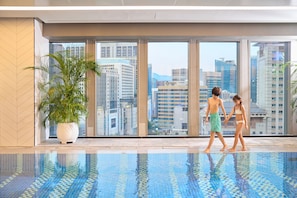A modern indoor swimming pool with large windows offering city views. - Le Méridien Seoul, Myeongdong (Seoul)