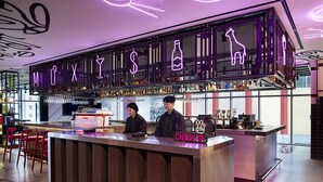 A bar area with a neon sign reading "MIXIS" and a "CHECK IN" sign. - Moxy Seoul Myeongdong (Seoul)