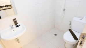 A small, modern bathroom with a white sink, toilet, and shower. - Clean Studio With Connected To Mall At Orchard Supermall Mansion Apartment (Surabaya)