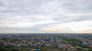 A residential area with houses and a distant tower. - Clean Studio With Connected To Mall At Orchard Supermall Mansion Apartment (Surabaya)