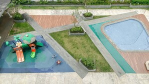 A children's play area with a slide and a small pool. - Modern Look Studio Room At Citra Living Apartment (Jakarta)