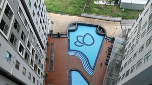 A modern building with a rooftop pool featuring a unique design. - Nice And Comfy 2Br Apartment At Royal Olive Residence (Jakarta)