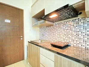 Private kitchen - Comfy Studio Apartment at Harvard Jatinangor (Cileunyi)