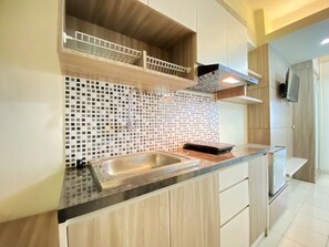 Private kitchen - Comfy Studio Apartment at Harvard Jatinangor (Cileunyi)