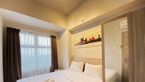 A hotel room with a large bed, a window with curtains, a painting of a cityscape, and an air conditioning unit. - Relaxing 1Br At Apartment At Newton Residence Bandung (Bandung)