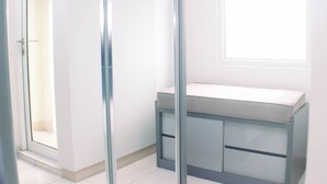 A room with a window, a built-in bench, and a door leading to another room. - Good Deal And Comfy Studio Apartment Springlake Summarecon Bekasi (Bekasi)