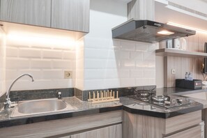 Studio, 1 Bedroom | Private kitchen | Fridge, stovetop, cookware/dishes/utensils, dining tables - Nice Studio At 11Th Floor Transpark Cibubur Apartment (Depok)