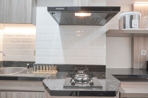 Studio, 1 Bedroom | Private kitchen | Fridge, stovetop, cookware/dishes/utensils, dining tables - Nice Studio At 11Th Floor Transpark Cibubur Apartment (Depok)