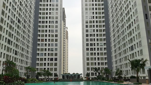 A swimming pool surrounded by high-rise residential buildings. - Nice Designed And Comfort 2Br Apartment At M-Town Residence (Gading Serpong)