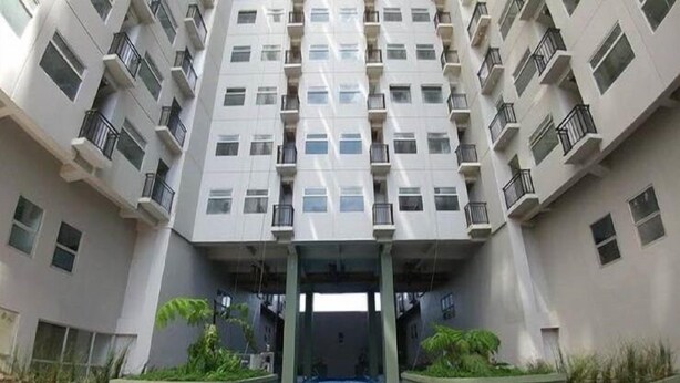 Un edificio de gran altura con un patio central que incluye una piscina.
