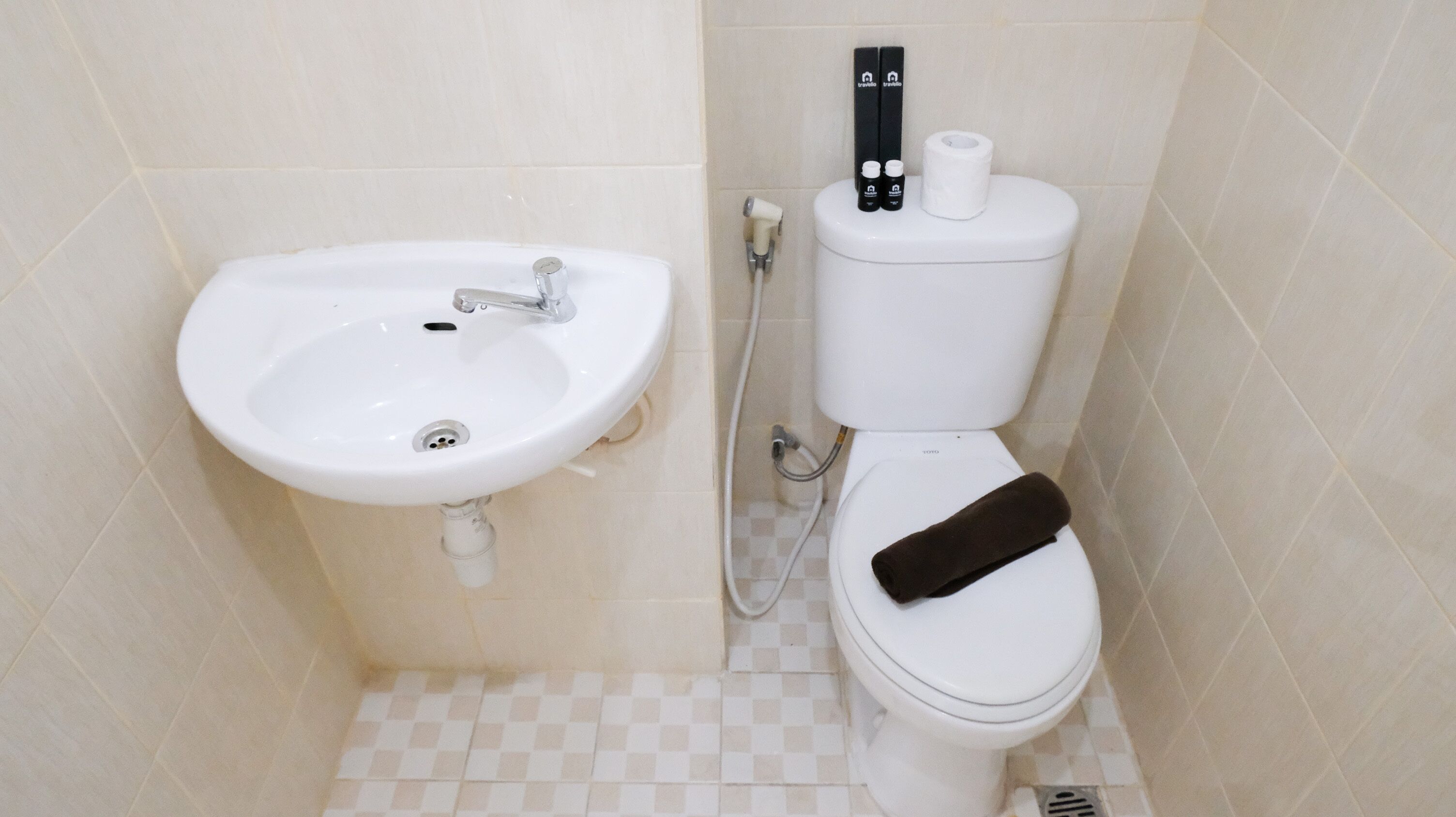 A bathroom with a white sink, toilet, and a towel rack.