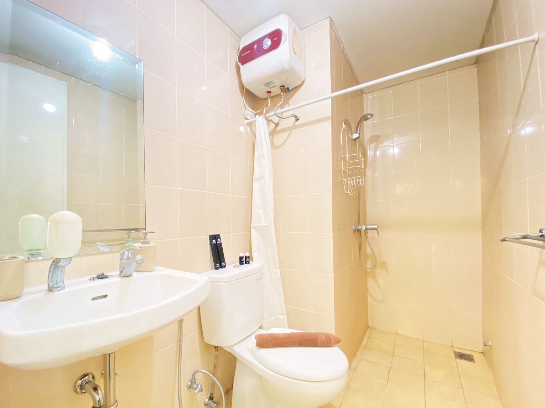 A bathroom with a sink, toilet, and shower.