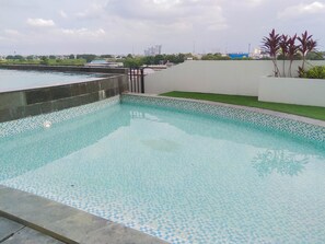 Outdoor pool - Simply And Well Design Studio Room At Patraland Urbano Apartment (Bekasi)