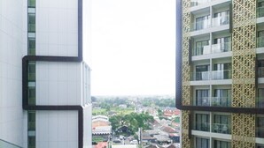 A high-rise building with a view of a residential area below. - New Studio At Patraland Amarta Apartment (Ngaglik)