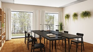 A conference room with a long table, chairs, a bookshelf, and large windows with curtains. - Toivo Studios (Espoo)