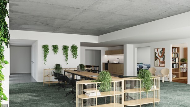 A modern office space with a large desk, chairs, and shelves with plants. There is a kitchen area in the background. - Toivo Studios (Espoo)
