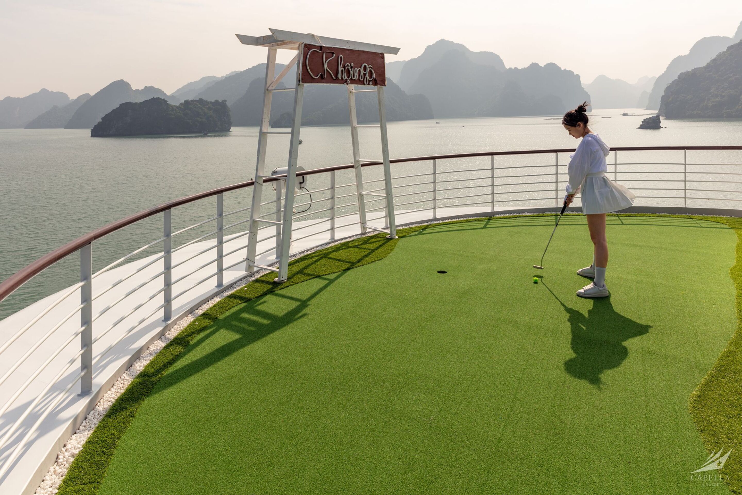 A golf course with a sign reading "CR Khong".