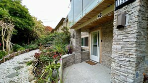 A house with a stone facade, a number sign '11268', and a gated entrance. - Fully AirConditioned Resort Style home living w/Hottub,outdoor shower and  pool. (Delta)