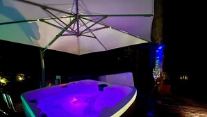 A hot tub under an umbrella at night. - Fully AirConditioned Resort Style home living w/Hottub,outdoor shower and  pool. (Delta)