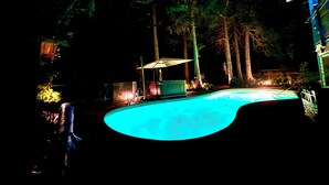 A swimming pool surrounded by trees and a building. - Fully AirConditioned Resort Style home living w/Hottub,outdoor shower and  pool. (Delta)