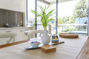 Enjoy a meal with a view from this kitchen, featuring a large window and modern cabinetry.