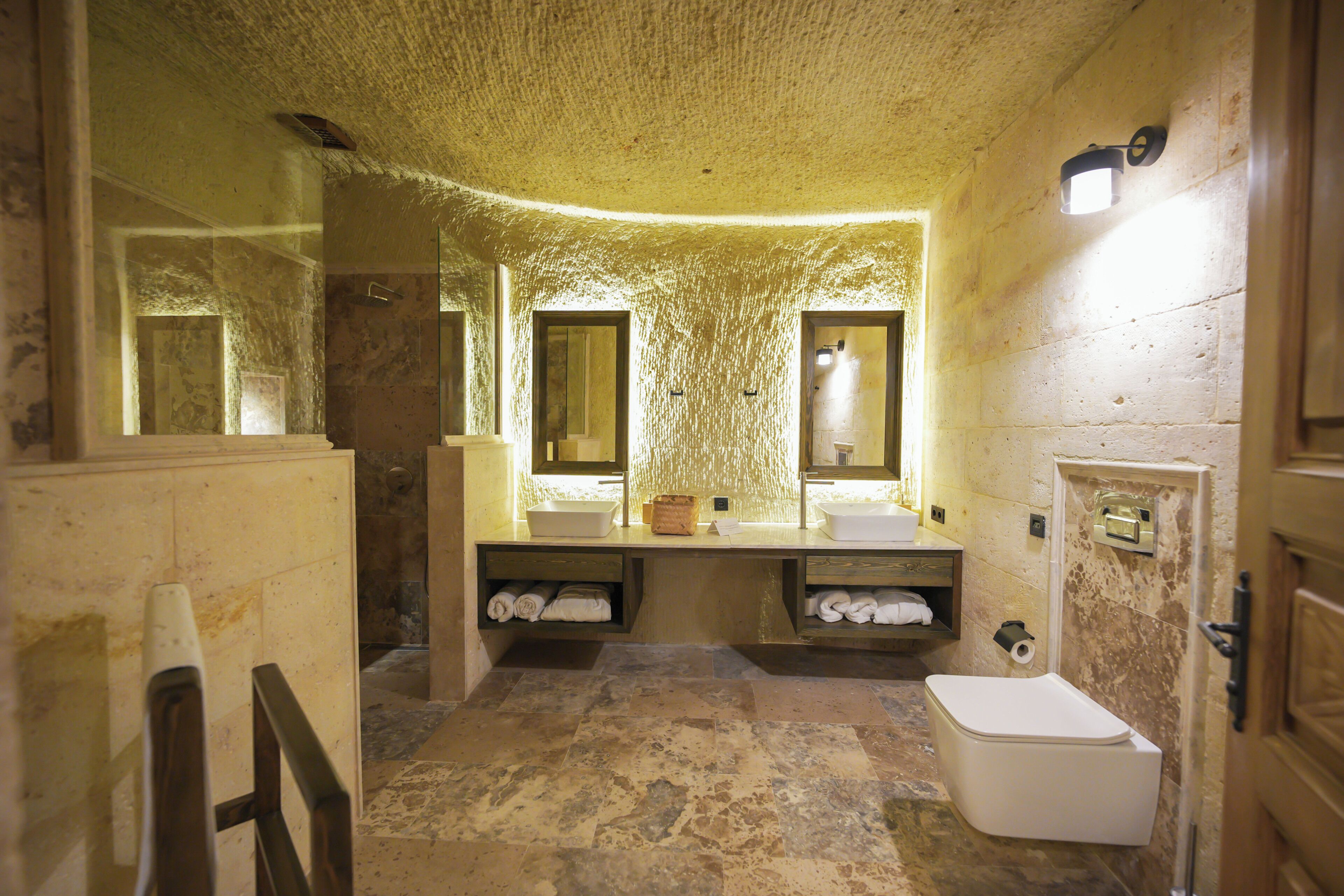A bathroom with a sink, mirror, towel rack, and toilet.