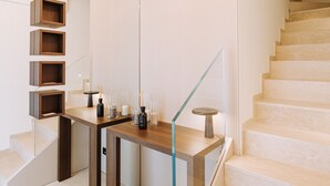 A modern interior with a staircase, wooden shelves, and a glass railing. - Suite1212 Bandiera  (Monopoli)
