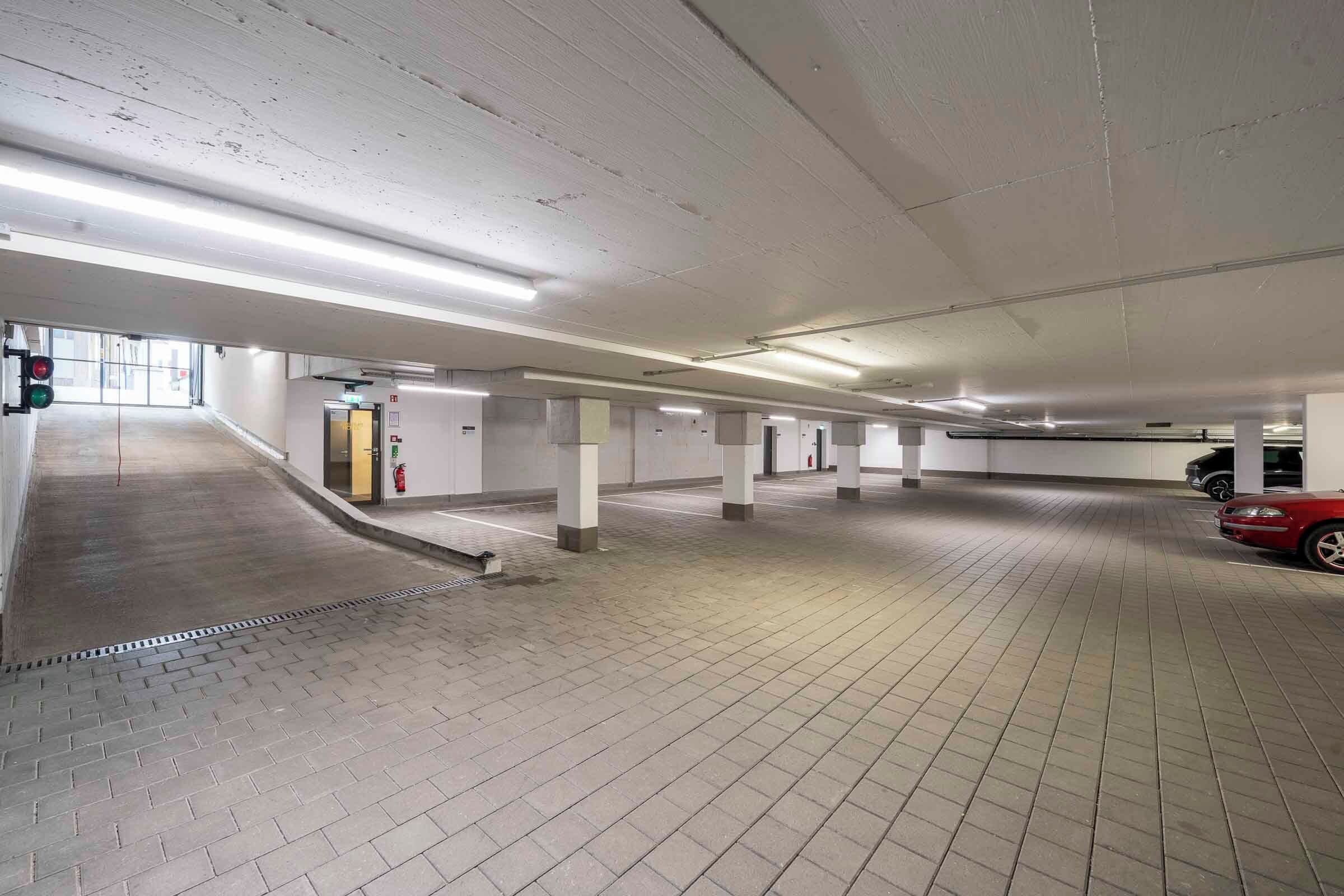 A multi-level parking garage with a ramp leading to an upper level.