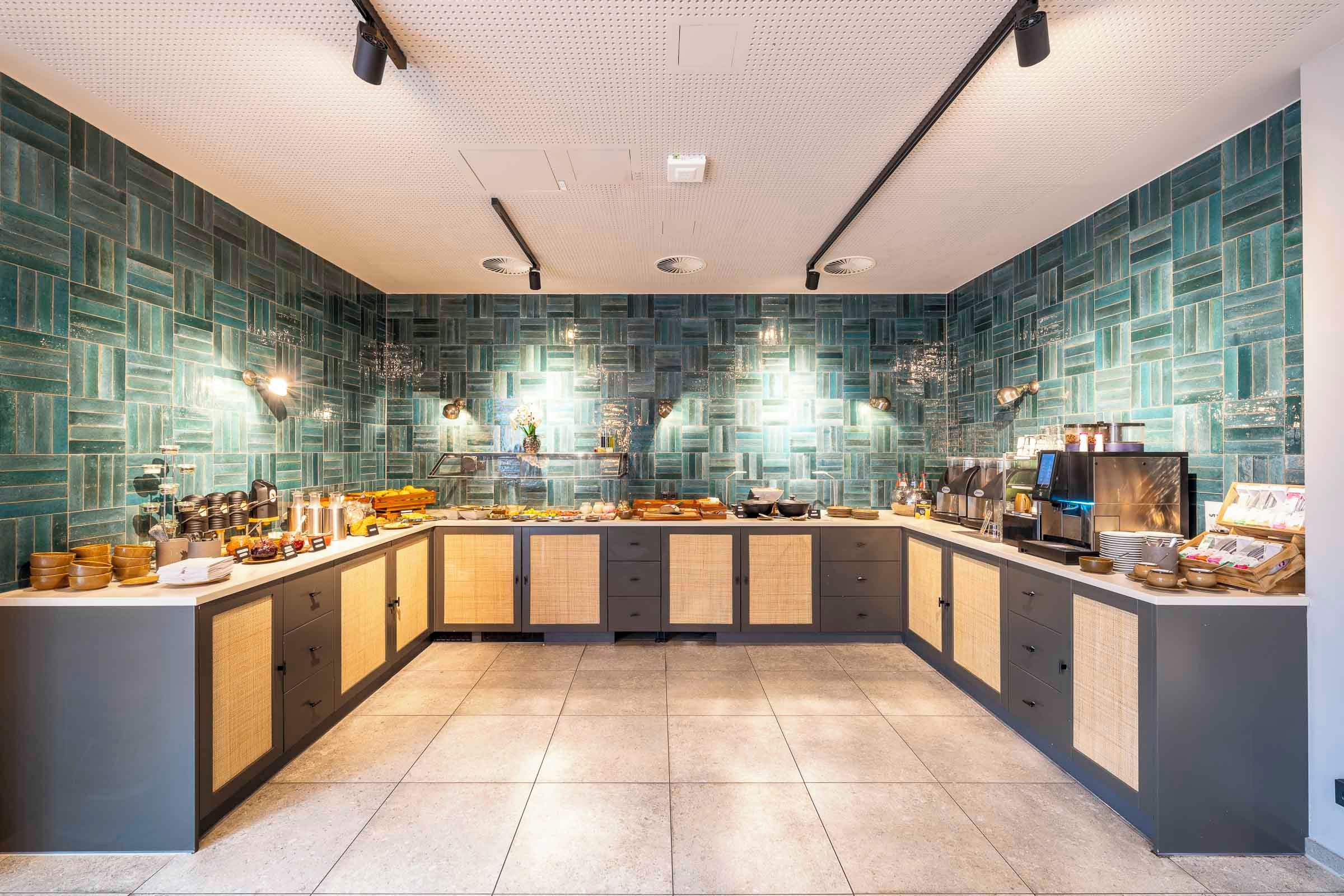 A modern kitchen with a central island, equipped with various appliances and utensils.