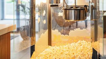A popcorn machine with a transparent front, allowing visibility of the popcorn inside.