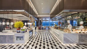 Una cocina moderna con piso a cuadros, encimeras de mármol y una isla central.