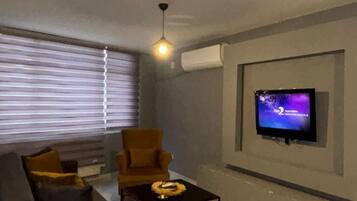 Superior Apartment | Living area | 106-cm LCD TV with satellite channels, TV, pay movies