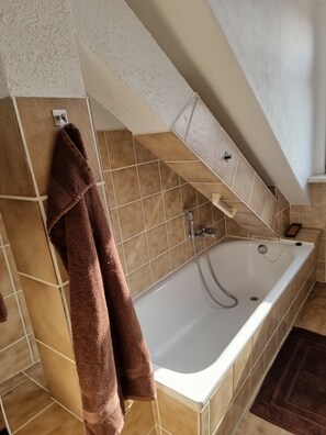 Bathtub, towels, toilet paper