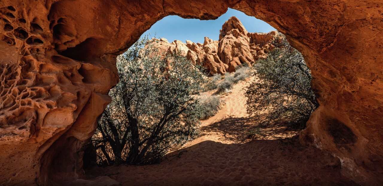 A natural rock formation with a clear view through a cave opening.