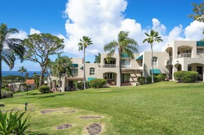 A resort with multiple buildings, palm trees, and a well-maintained lawn. - Palms at Wailea #1207 Ground Floor Unit, Near Complex Pool and Shared Hot Tub (Wailea)