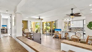 A spacious living area with a kitchen, dining area, and a balcony with sliding glass doors. - Palms at Wailea #1207 Ground Floor Unit, Near Complex Pool and Shared Hot Tub (Wailea)
