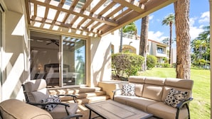 A covered outdoor seating area with a sofa, chairs, and a table. - Palms at Wailea #1207 Ground Floor Unit, Near Complex Pool and Shared Hot Tub (Wailea)