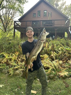Guests can enjoy fishing in the surrounding waters, with a balcony offering a scenic view of the lush surroundings.