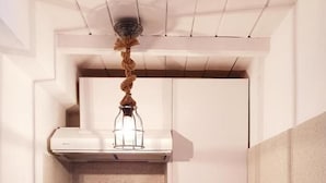 A compact kitchenette with a built-in oven, microwave, and coffee maker. - Cute studio in downtown Mykonos (Mykonos)