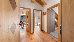 A wooden interior with a hallway leading to a dining area. - Töniglerhof  "Apartment Morgensonne" with Mountain View, Garden & Wi-Fi (Trodena)