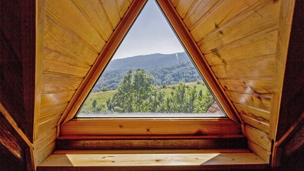 A triangular wooden window with a view of a green landscape and hills. - Andrea in Sertić Poljana  - Haus für 6 Personen (Plitvička jezera)