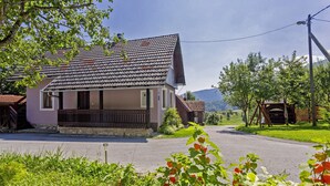 A two-story house with a tiled roof, a porch, and a small garden area. - Andrea in Sertić Poljana  - Haus für 6 Personen (Plitvička jezera)