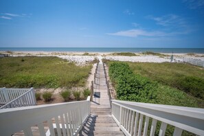 A wooden boardwalk leading to a beach with white sand and dunes. - Gulf-front, private pool, pets welcome! (Port Saint Joe)