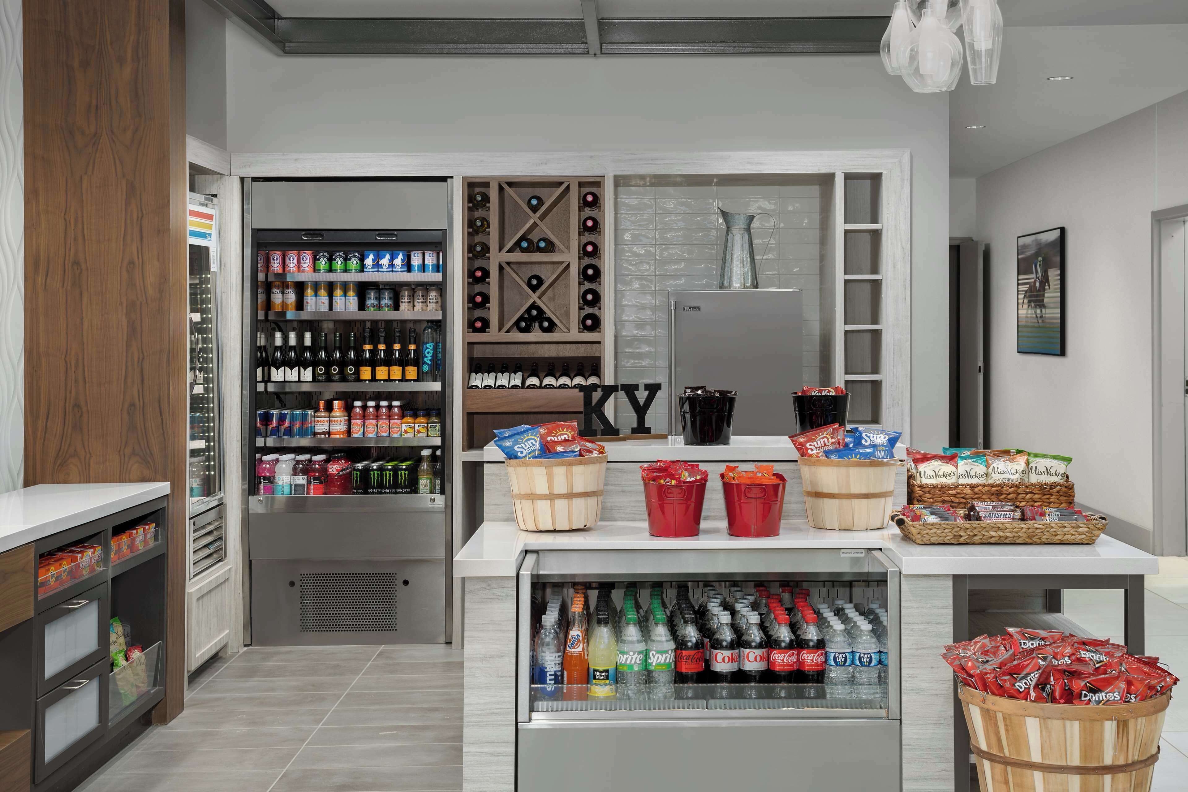 A snack bar with a variety of beverages and snacks, including bottled drinks and packaged snacks.