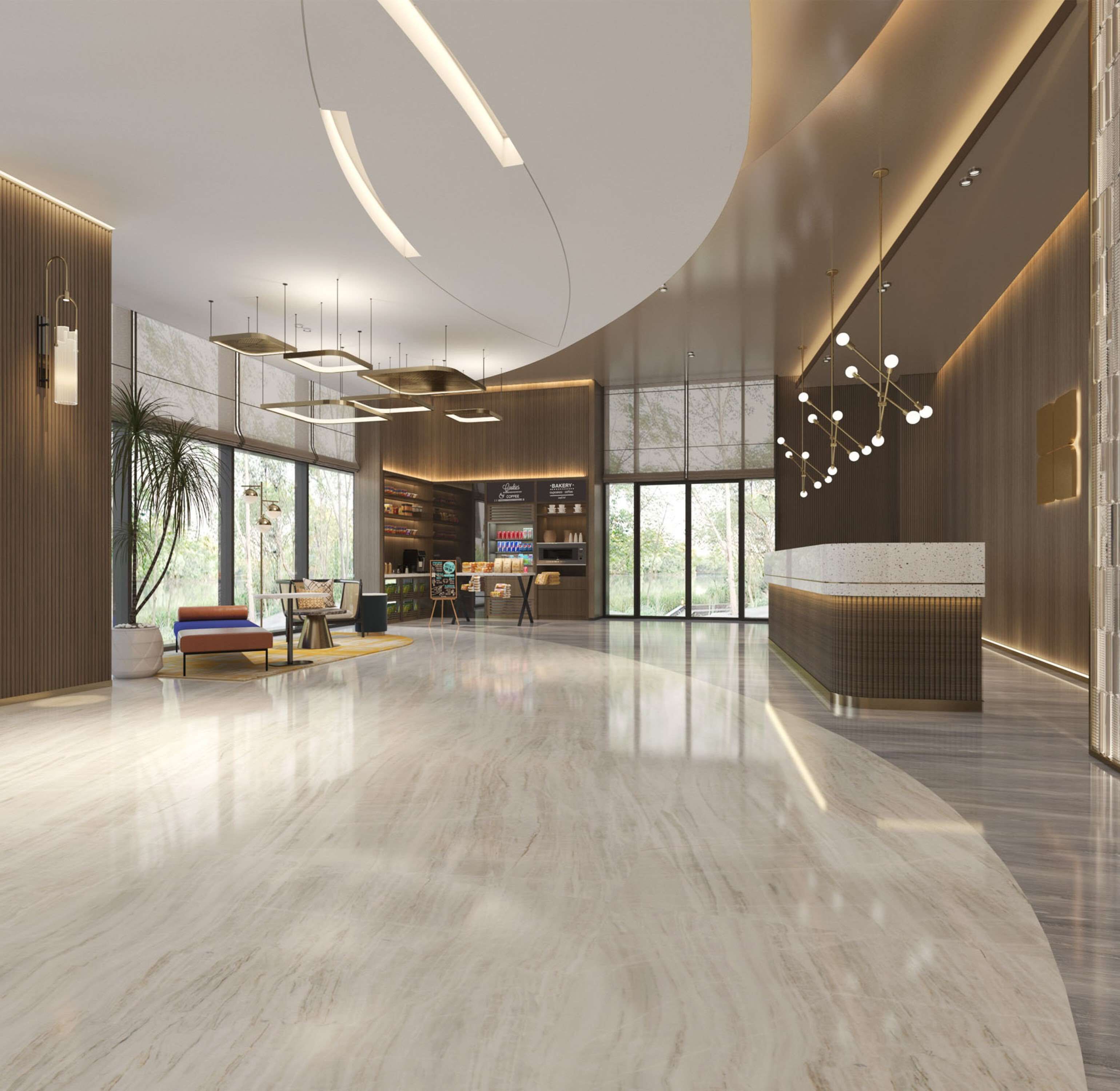 A spacious lobby with a curved ceiling, a reception desk, and a seating area with a sofa and chairs.