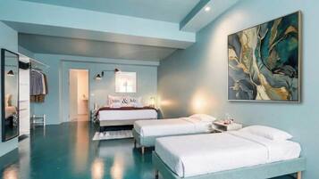 A modern hotel room with two beds, a large abstract painting, and a mirror.