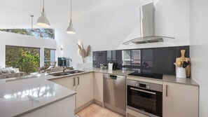 Enjoy cooking in this well-equipped kitchen with a large island, sink, and ample counter space.